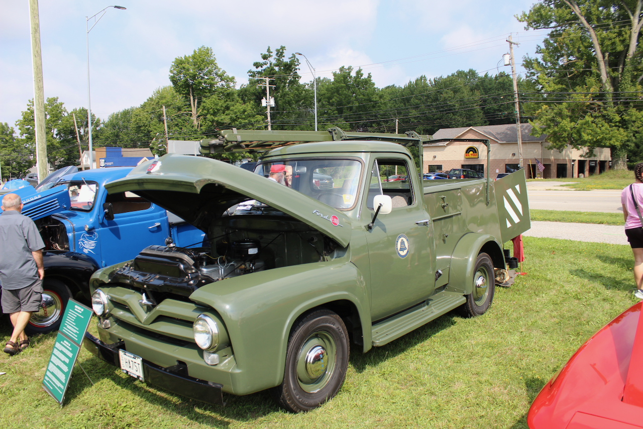 1950s Ford utility truck, olive green, hood open front three-quarter view