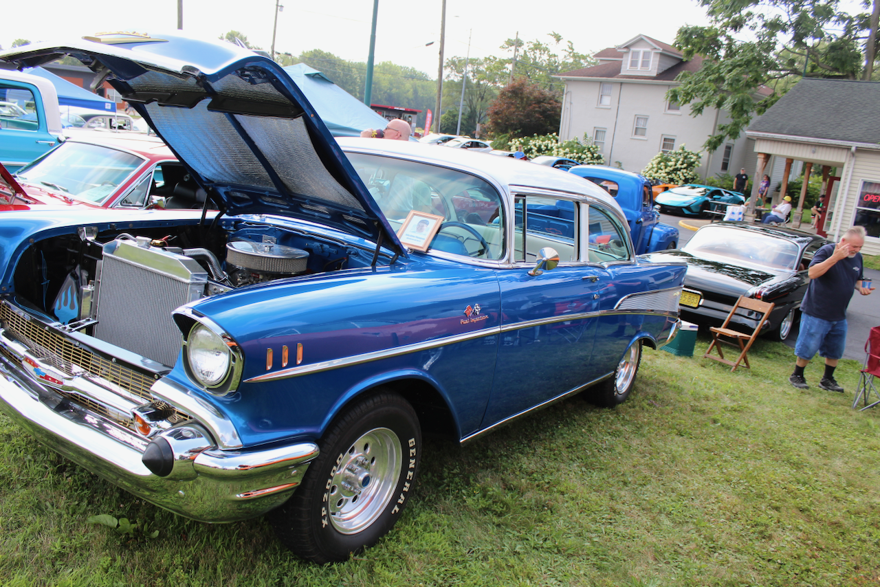 1957 Chevrolet Bel Air, blue and white, hood open front three-quarter view