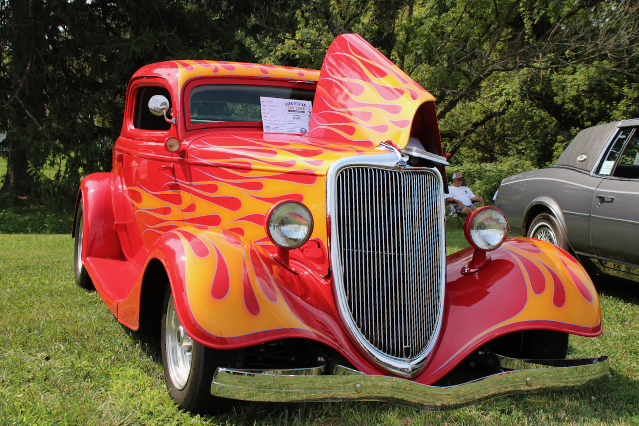 1937 Ford pickup hot rod, red with yellow flames, front three-quarter view