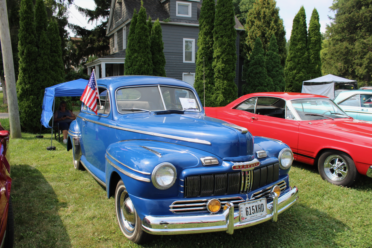 1940s Mercury coupe, blue, front three-quarter view with American flag