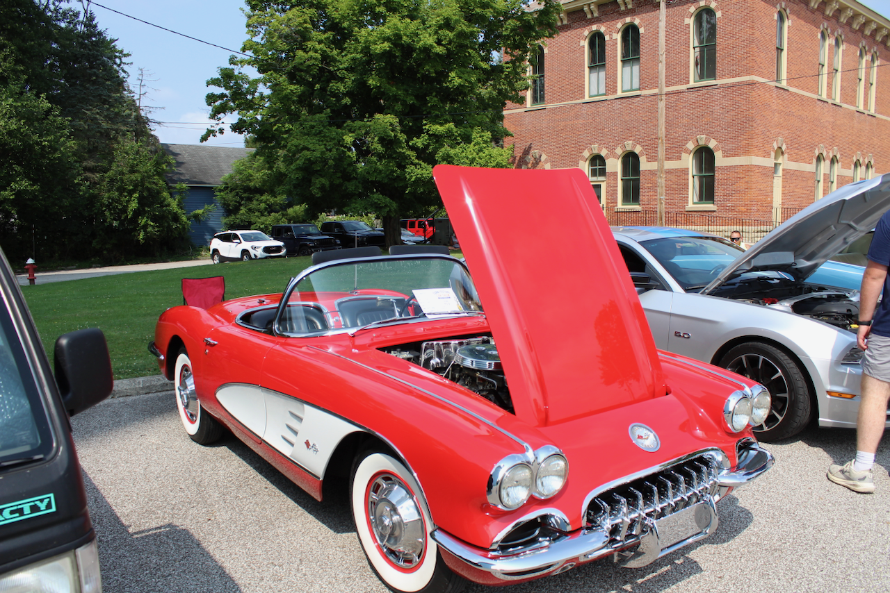 1960s Chevrolet Corvette convertible, red and white, hood open front three-quarter view