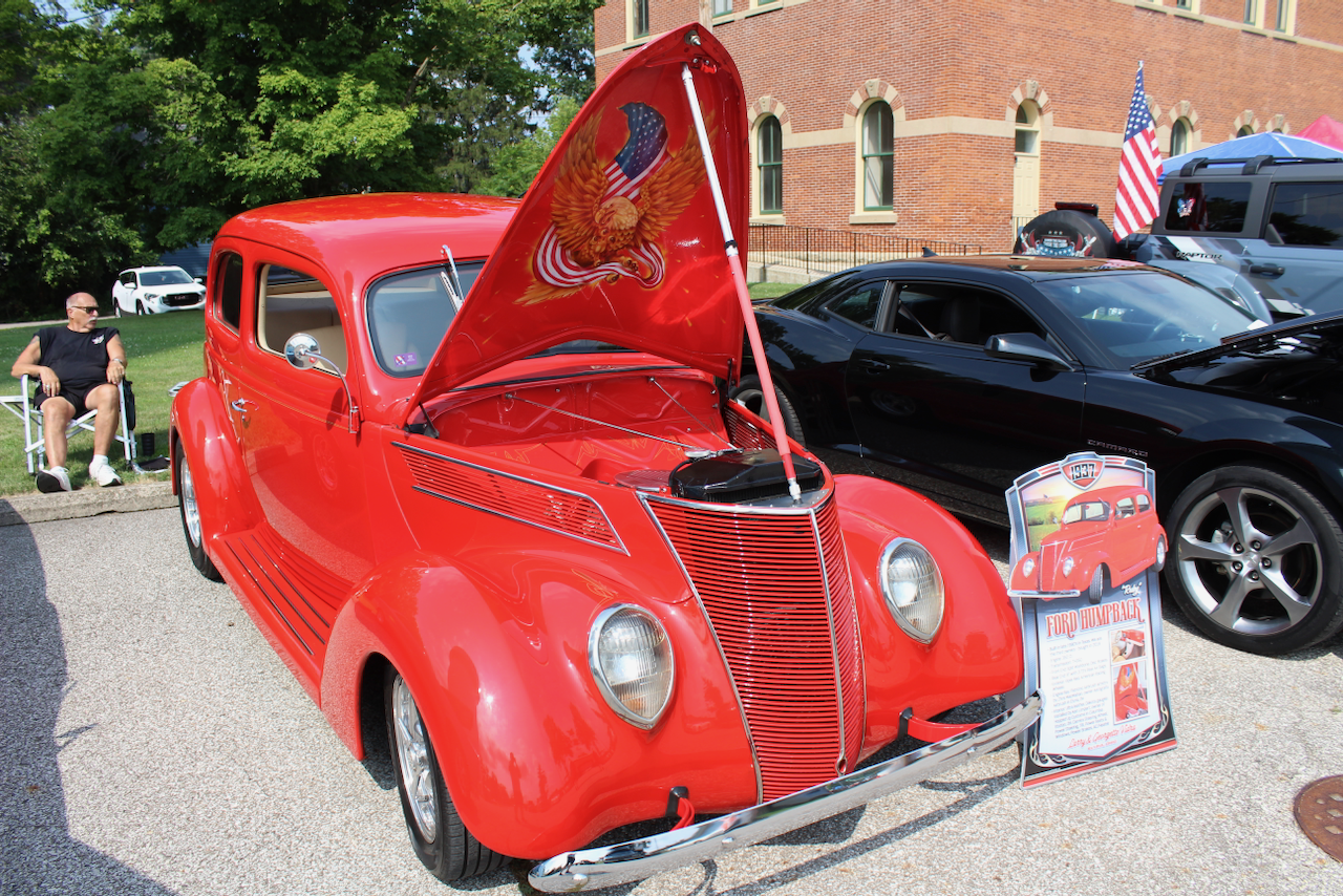 1937 Ford humpback sedan, red, hood open front three-quarter view